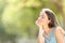 Smiley woman meditating and relaxing in a forest