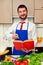 Smiley young man pointing at the cookbook