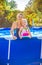 Smiling active mother and daughter in swimming pool