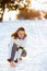 Smiling active woman in white jacket tying your shoelaces