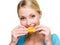 Smiling adult girl eats the fresh orange