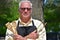 Smiling Adult Retired Male Cook With Utensils