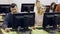 Smiling adult students of different ages looking together at monitor during computer classes at university of third age