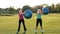 Smiling adult women doing ab exercises with balls