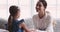 Smiling affectionate mixed race mother supporting daughter.