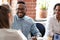 Smiling African American businessman at company meeting