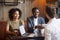 Smiling african-american couple shaking hands to broker advisor