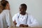 Smiling African American doctor talking to patient at visit