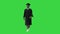 Smiling African American Male Student in graduation robe walking on a Green Screen, Chroma Key.