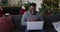 Smiling african american man having video call, sending kisses, christmas decorations in background