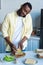 smiling african american man making sandwiches