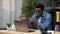 Smiling African American man trader businessman talks online laptop webcam chat
