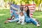 smiling african american parents and daughter holding american flag at picnic