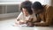 Smiling African American preschool daughter and father drawing pencils