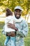 smiling african american soldier in military uniform holding daughter