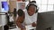 Smiling african american woman, a confident musician, composing a soulful song in a music studio, engrossed in her musical world