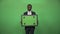 Smiling african businessman holding chromakey board