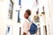 Smiling african female walking on the narrow street with bag