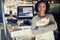 Smiling African waitress standing at the counter of a restaurant