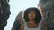 Smiling african woman standing rocky Ursa beach lighted sunlight close up.