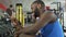 Smiling Afro-American athlete taking selfie in the gym, modern technologies