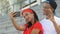 Smiling Afro-American teen couple fooling around and making selfie outdoors