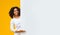 Smiling Afro Girl Pointing At White Advertisement Board For Your Text