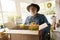 Smiling aged man packing orders in flower shop