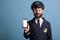Smiling airplane captain showing modern phone