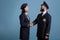 Smiling airplane pilot and flight attendant shaking hands portrait