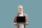 Smiling albino guy showing laptop computer blank screen to camera, standing over turquoise background