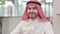 Smiling Arab Businessman Looking at Camera in Office