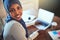 Smiling Arabic female entrepreneur working online in her home of