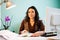 Smiling architect with color pallete on her desk