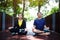 Smiling Asian couple in sportwear sitting and doing yoga for meditation for create concentration and calm the mind.