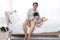 Smiling Asian cute little boy is relaxing and hugging with father in bedroom at home. Family love and child educational for
