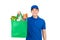 Smiling Asian delivery man holding grocery shopping bag isolated on white background