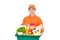Smiling Asian delivery man in orange uniform holding grocery basket