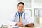 Smiling Asian doctor with digital tablet looking at camera. Remote online medical chat consultation, tele medicine distance