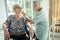 Smiling asian female elderly person wipe sweat on the skin face of the senior sister and talk happily,old people visited her  aged