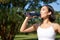 Smiling asian fitness girl drinks water, workout in park, stay hydrated during jogging training session