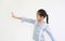 Smiling asian little kid girl showing five finger stop posture and looking straight beside on white background. Side view