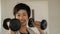 Smiling Asian short hair woman fitness dumbbell lifting. exercise