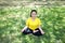 Smiling Asian young woman in sportwear close her eyes and sitting for doing yoga of meditation for create concentration and calm