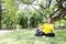 Smiling Asian young woman in yellow sportwear sitting and doing yoga for meditation for create concentration and calm the mind.