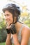 Smiling athletic brunette putting on helmet