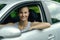 Smiling attractive woman driving a car