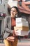 smiling attractive woman holding shopping boxes