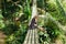 smiling attractive woman sitting on wooden footbridge