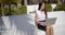 Smiling attractive young woman on a park bench